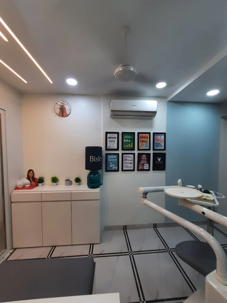 Smile Plus Dental Clinic interior with framed dental care posters and water station, Powai, Mumbai