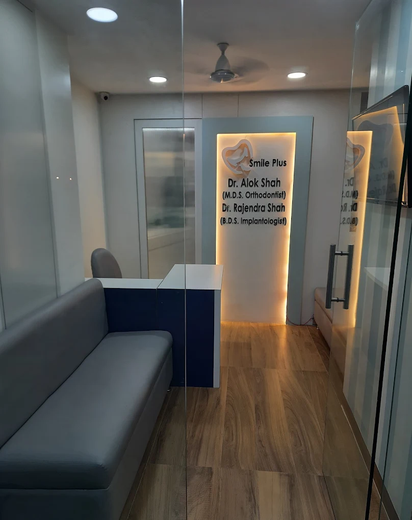 Smile Plus Dental Clinic reception area with seating and doctors' name wall, Powai, Mumbai